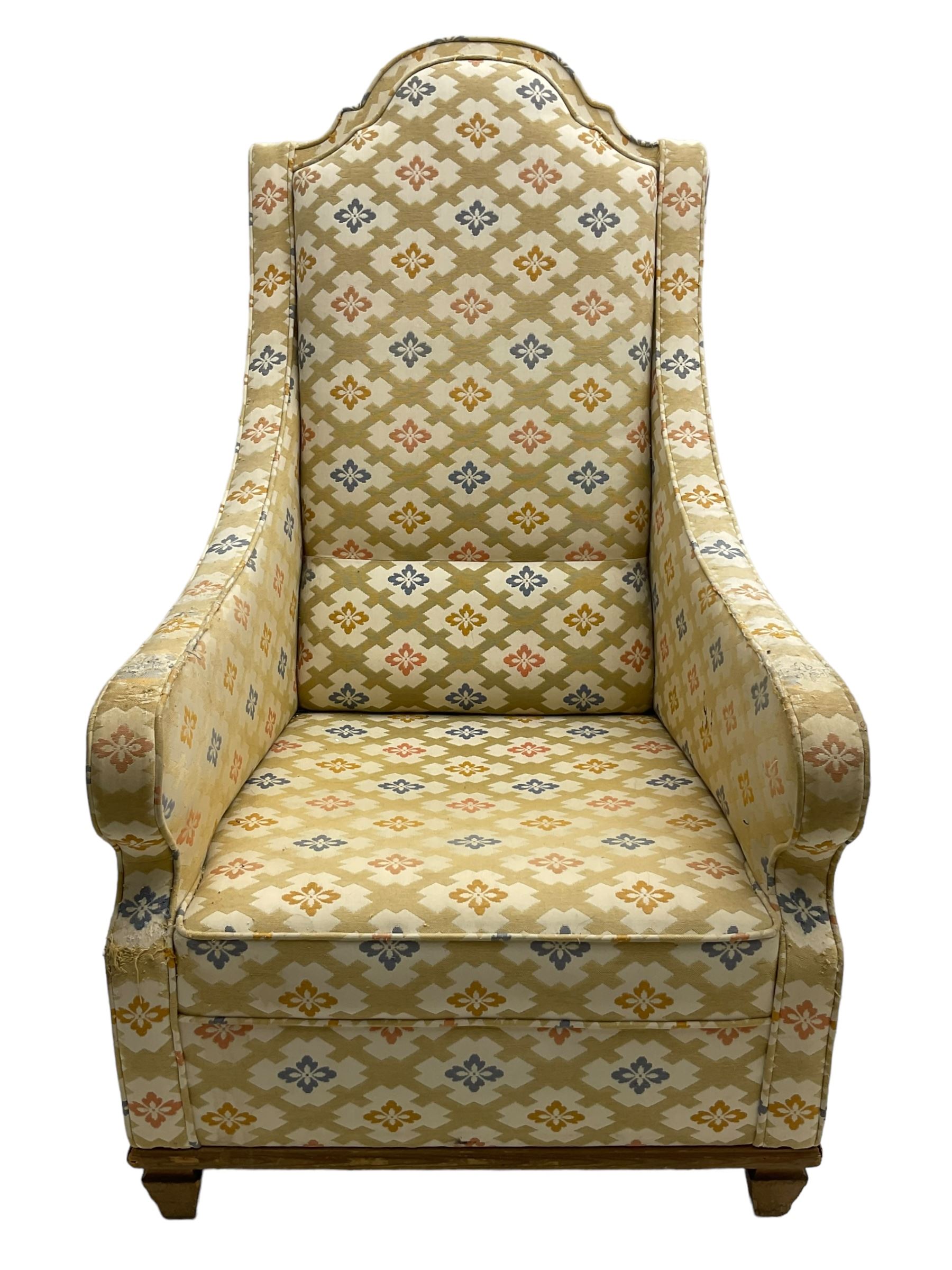 Spanish high back throne armchair, arched cresting rail over scooped arms, upholstered in gold and ivory patterned fabric, on a pitch pine base with spade feet