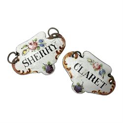 Two late 18th/early 19th century enamel wine labels, each of shaped form, titled 'CLARET', and 'SHERRY' and decorated with floral sprigs and scroll detail upon a white ground, each with suspension chain, each approximately H3.5cm W5cm