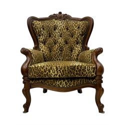 Pair of Victorian design stained beech armchairs, upholstered in leopard print fabric, with carved top rail over button-tufted backrest, scroll arms, serpentine front rail, raised on cariole supports