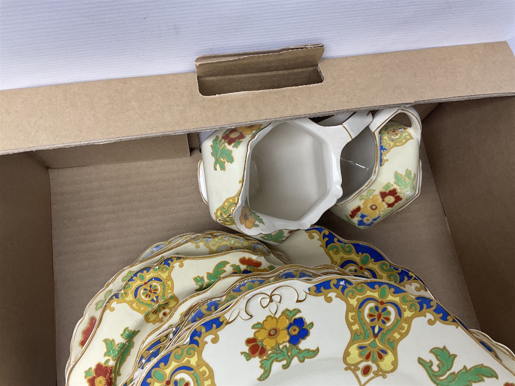 Minton Marlow pattern tea and dinner wares, including dinner plates, side plates, tea cups, cake plate, etc together with Bishops & Stonier 'Bisto' green and gilt tea wares and Maddock Ivory Ware dinner wares, in three boxes