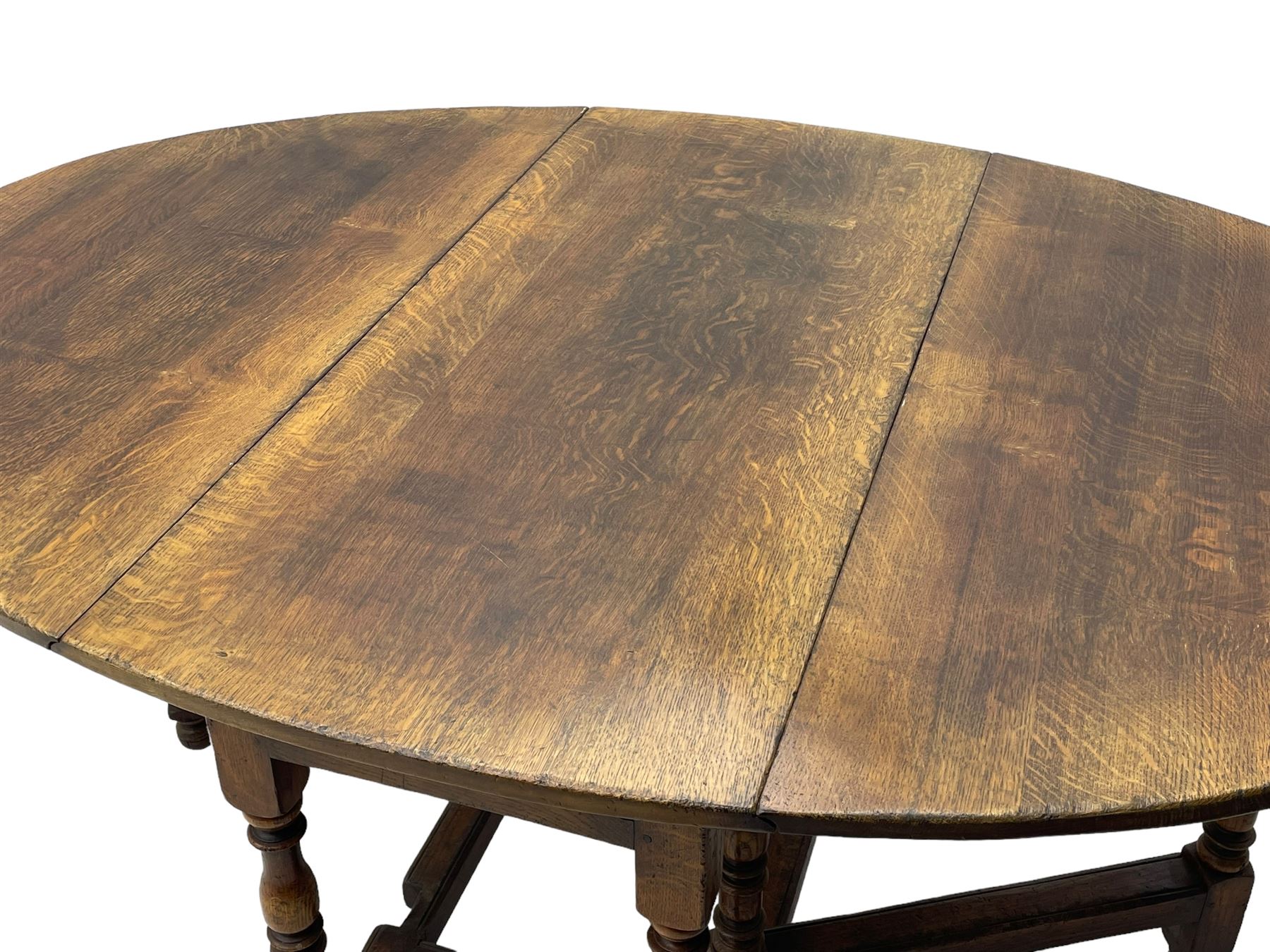 18th century oak dining table, oval drop-leaf top on gate-leg action base, turned supports united by turned stretchers, fitted with single end drawer