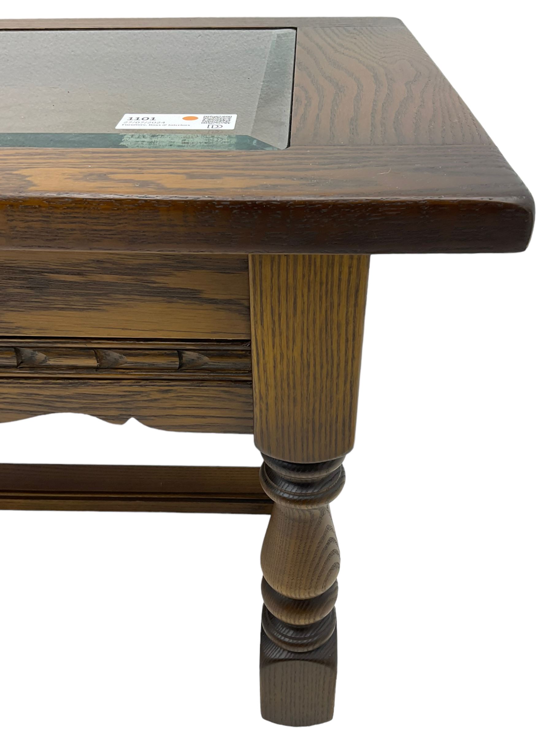 Old Charm - oak coffee table, rectangular top with glass inset over carved scalloped apron, on turned square supports connected by H-stretcher