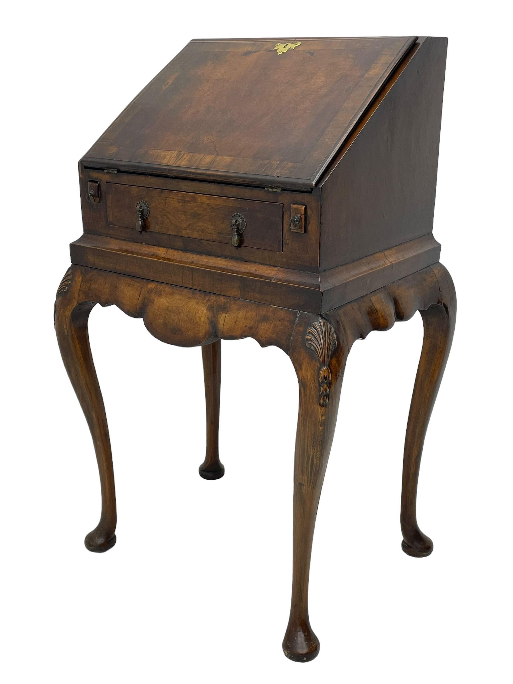 20th century walnut bureau, hinged fall front with moulded edge and cross banding over single drawer, the interior fitted with six pigeonholes and three drawers, on shell and bell flower carved cabriole supports, scalloped apron and side rails 