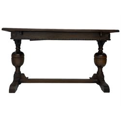 Early 20th century oak extending table, moulded rectangular top, pull-out action with fold-out leaf, on turned cup and cover pedestals and sledge feet, united by moulded stretcher 