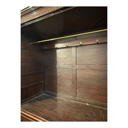 Victorian mahogany linen press, projecting cornice with dentil and scroll detailing, double panelled doors opening to an interior fitted with a brass hanging rail and coat hooks, lower section with two drawers and fitted shelves for additional storage, raised on bracket feet