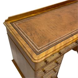 Victorian satin walnut twin pedestal desk, moulded rectangular top with rounded corners and raised back, inset leather writing surface with tooled borders, fitted with nine drawers with turned handles, on moulded plinth base 