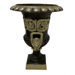 20th century cast iron Campana-shaped urn on plinth, with scrolling foliate relief decoration, in ebonised and silver painted finish