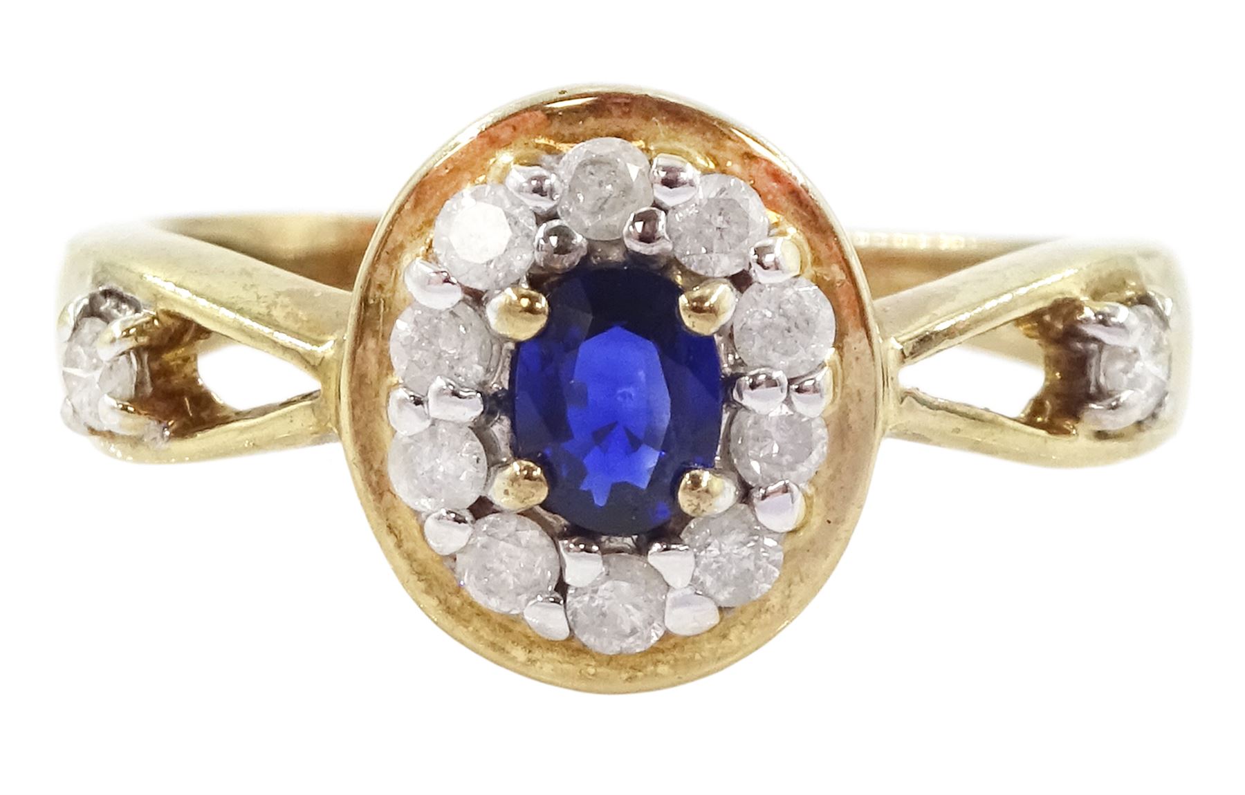 9ct gold oval cut sapphire and round brilliant cut diamond cluster ring, with diamond set shoulders, hallmarked