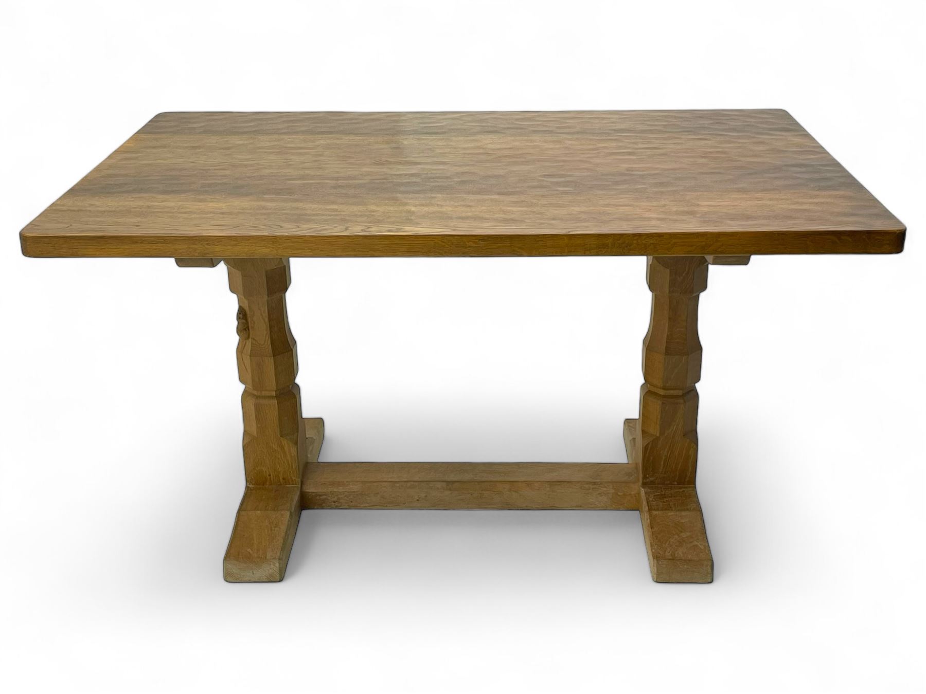 Mouseman - oak dining table, rectangular adzed top with rounded corners, octagonal pillar supports on sledge feet united by floor stretcher, carved with mouse signature, by the workshop of Robert Thompson, Kilburn