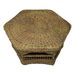 Mid-20th century hexagonal wicker coffee table, featuring woven top with pattern that radiates from the centre, lower shelf for additional storage, supported by interwoven wicker legs