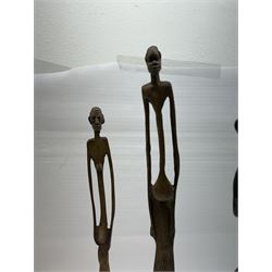 Five bronzed tribal figures, of elongated form, tallest H18cm