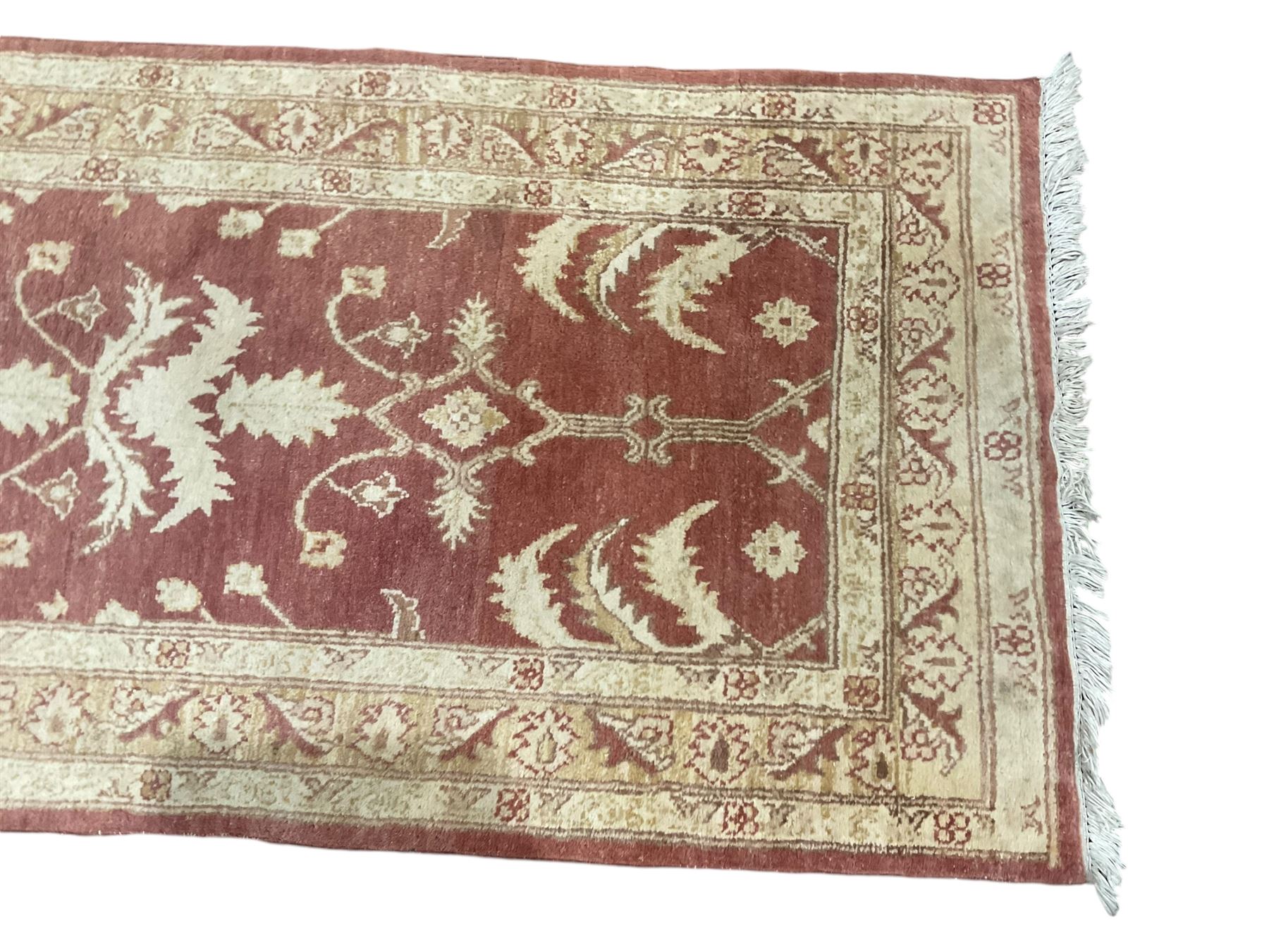 Persian Zeigler crimson ground runner rug, the field decorated with stylised foliate motifs and leafage, densely decorated guard band with floral and geometric patterns