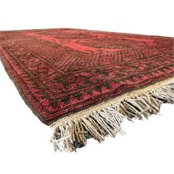 Afghan red ground Bokhara rug, decorated with four central Gul motifs, enclosed by wide geometric guard bands (191cm x 104cm); together with another similar (120cm x 79cm)