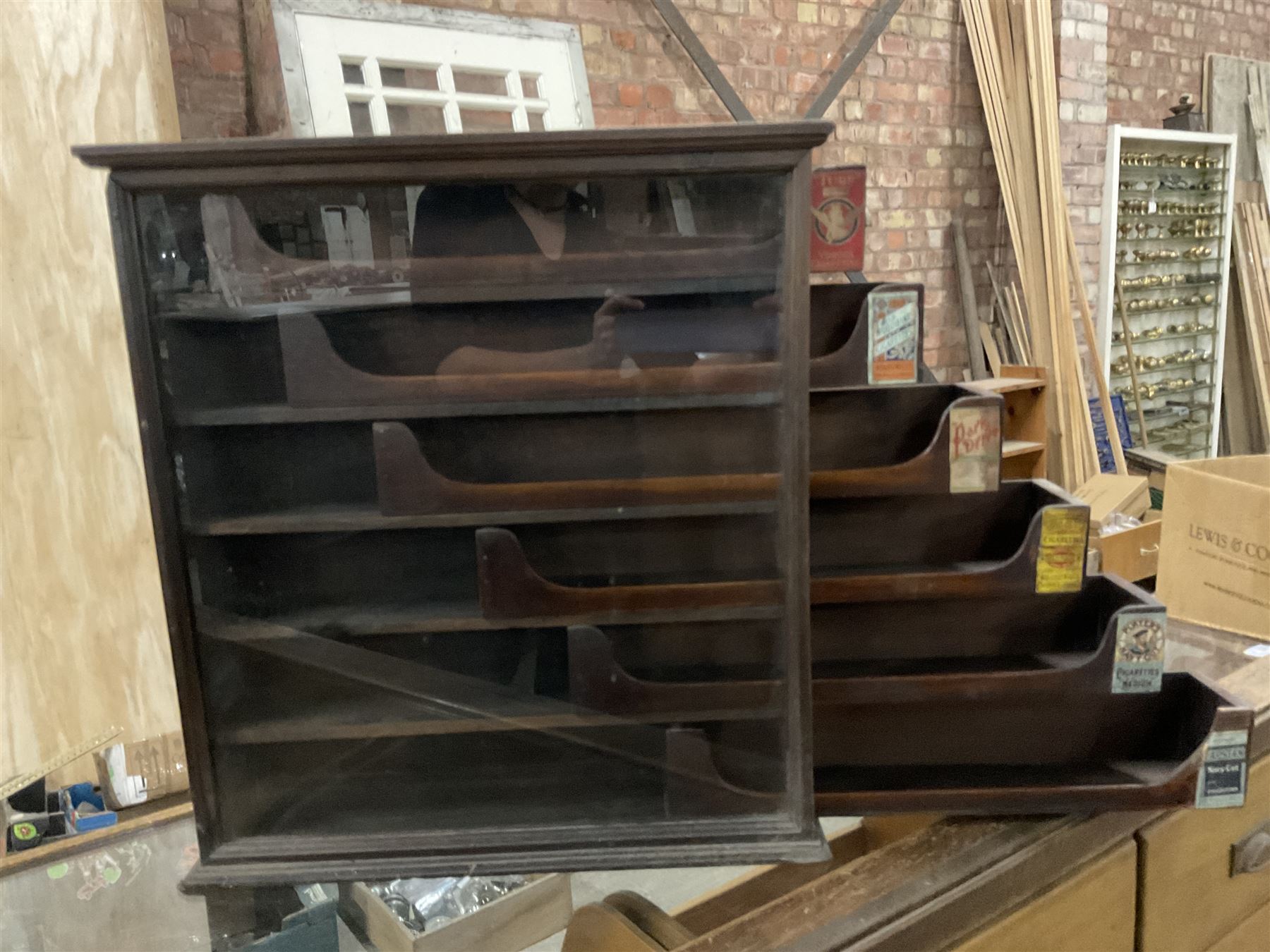 Early 20th stained pine and glazed wall mounting cigarette shop display cabinet, fitted with six sliding drawers with divisions and scalloped handles  - THIS LOT IS TO BE COLLECTED BY APPOINTMENT FROM THE OLD BUFFER DEPOT, MELBOURNE PLACE, SOWERBY, THIRSK, YO7 1QY