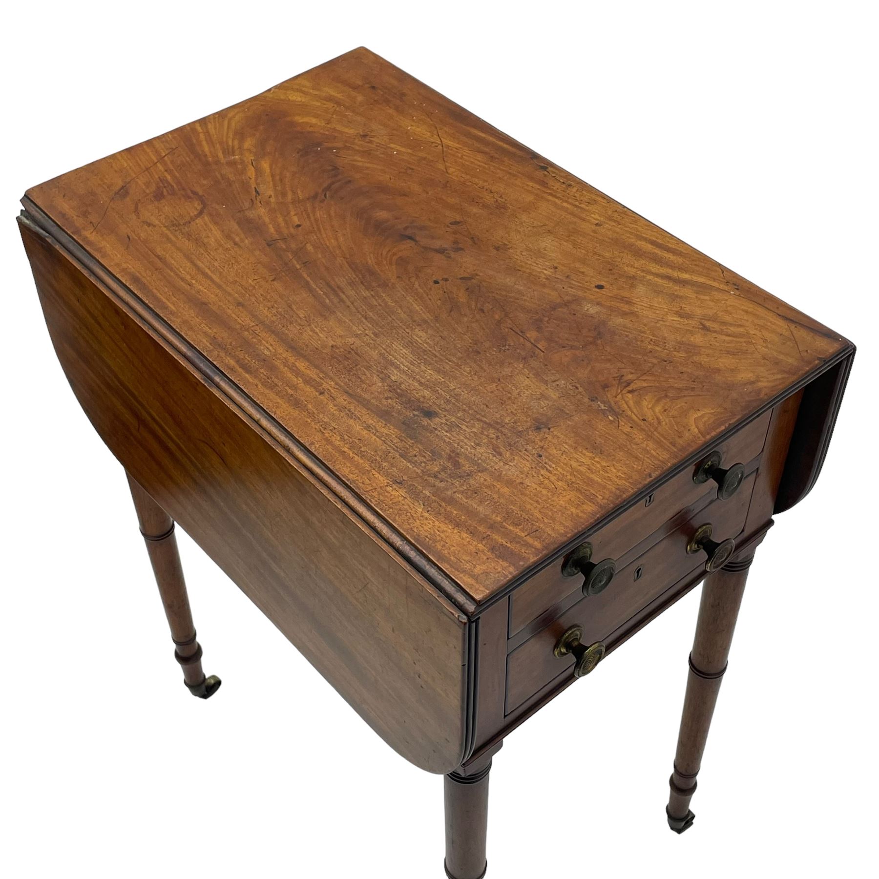 George III mahogany Pembroke table, reed moulded rectangular drop leaf top with rounded corners, fitted with two drawers opposing two false drawers, on ring turned supports with brass cups and castors 