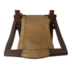 Victorian Aesthetic Movement mahogany framed folding campaign chair, pierced and carved cresting rail with carved and chamfered uprights, rattan back and seat