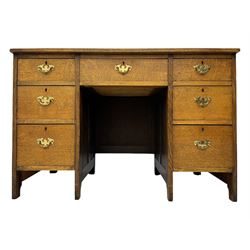 Edwardian oak twin pedestal desk, moulded rectangular top with inset writing surface, fitted with seven drawers, panelled sides, on stile supports 