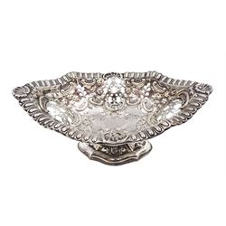 Victorian silver pedestal dish, of navette form, with egg and dart rim, pierced sides and embossed C scroll, foliate and floral decoration, upon a tapering lobed pedestal, embossed with flower heads, hallmarked Elkington & Co Ltd, Birmingham 1899, H6.5cm