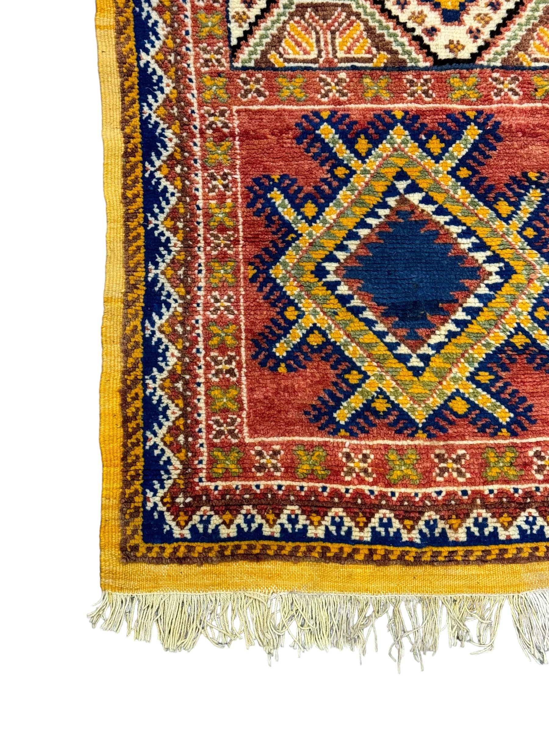 Persian Qashqai crimson ground rug, the field with central indigo and yellow medallion with geometric motifs, flanked by smaller medallions, border with repeating patterns (112cm x 200cm); Turkish Kazak light blue ground rug (109cm x 193cm); red ground runner with three octagonal medallions (69cm x 138cm)