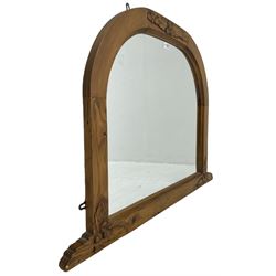 Pine arched overmantel mirror, the frame carved with oak leaves and acorns