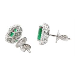 Pair of 18ct white gold oval cut emerald and round brilliant cut diamond stud earrings, stamped, total emerald weight approx 1.95 carat, total diamond weight approx 0.60 carat