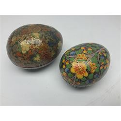 Seven lacquered boxes, of ovoid form, with floral decoration, largest H7cm, L10cm