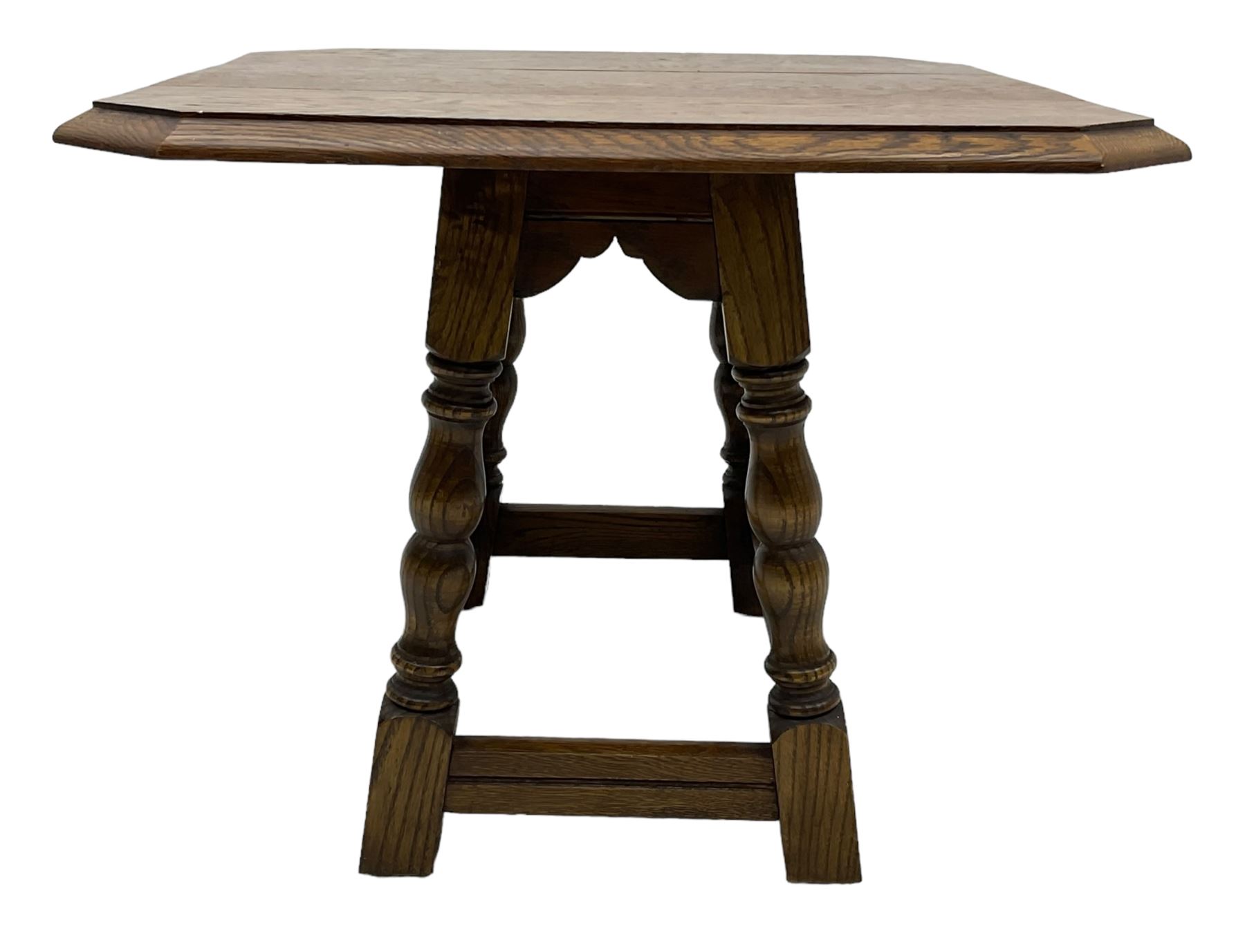 20th century oak drop-leaf table, bevel edged square top with cut corners, raised on splayed turned baluster supports united by stretchers