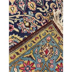 Persian indigo ground rug, overall arabesque design, central multi-point medallion surrounded by scrolling leafy branches and palmettes, the border decorated with repeating stylised plant motifs within guard stripes 