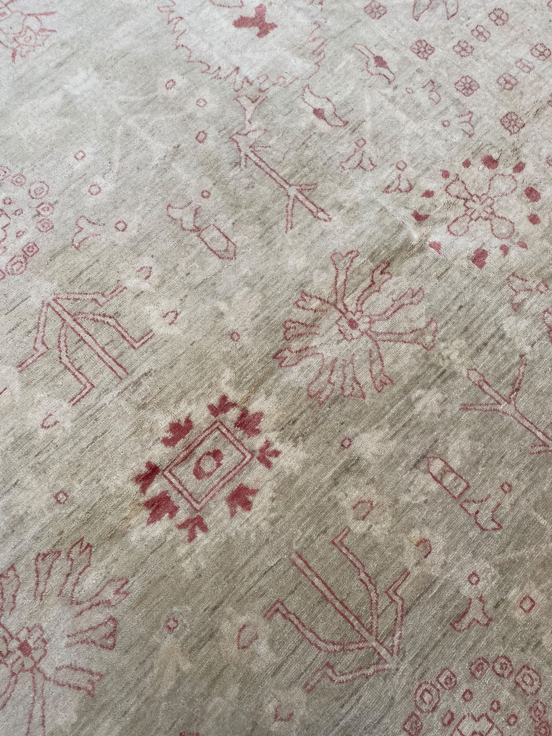 Persian design pale ivory ground carpet, decorated with stylised plant and leaf motifs in pale red