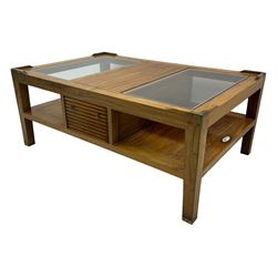 Starbay Tobago cherry wood coffee table, rectangular top with two inset glass panels, central drawer with louvred front and brass handles, flanked by open shelving, raised on square supports with metal corner brackets