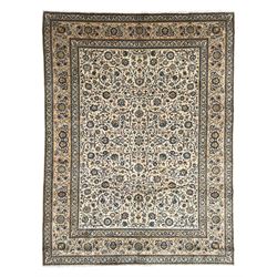 Persian Kashan ivory ground carpet, the busy field decorated with scrolling branches and p...