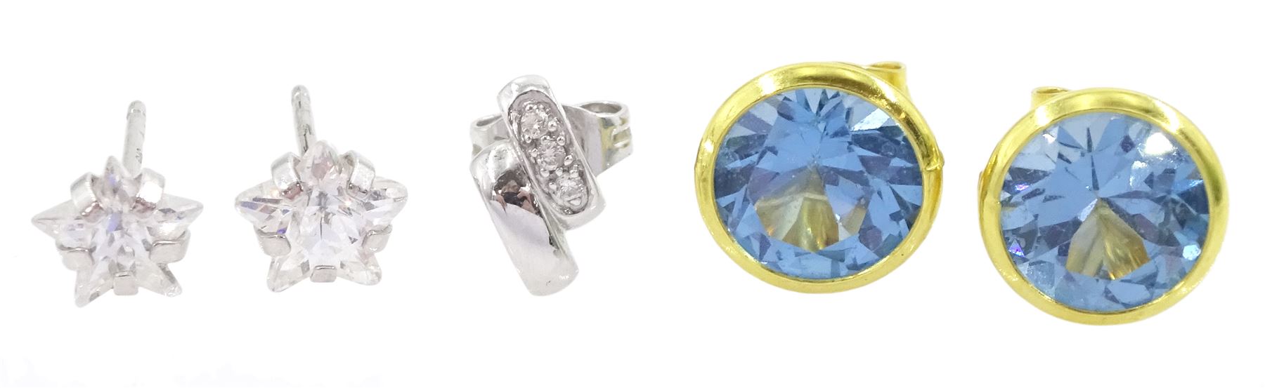 Pair of 14ct gold blue topaz stud earrings, pair of 9ct white gold cubic zirconia star stud earrings and a single 18ct white gold diamond earring