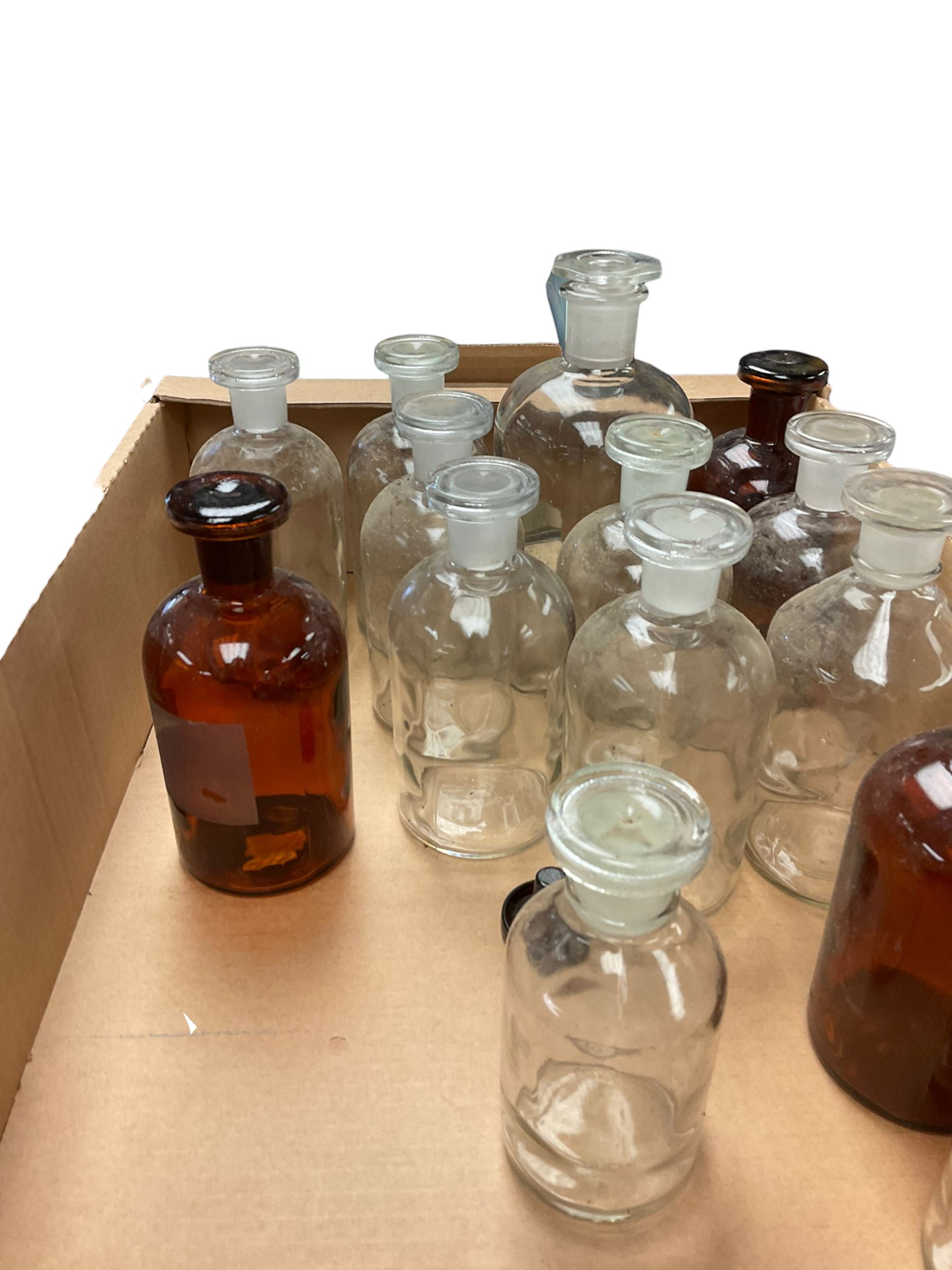 Collection of glass chemical bottles including amber glass examples