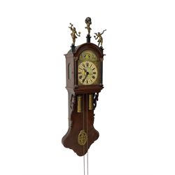 20th century weight driven Dutch WUBA wall clock -  with a break arch top and mounted gilt figures to the arch, painted dial with working moon disc, chapter ring with Roman numerals and pierced steel hands, twin train chain driven movement striking the hours on a bell. With pendulum and brass cased weights.