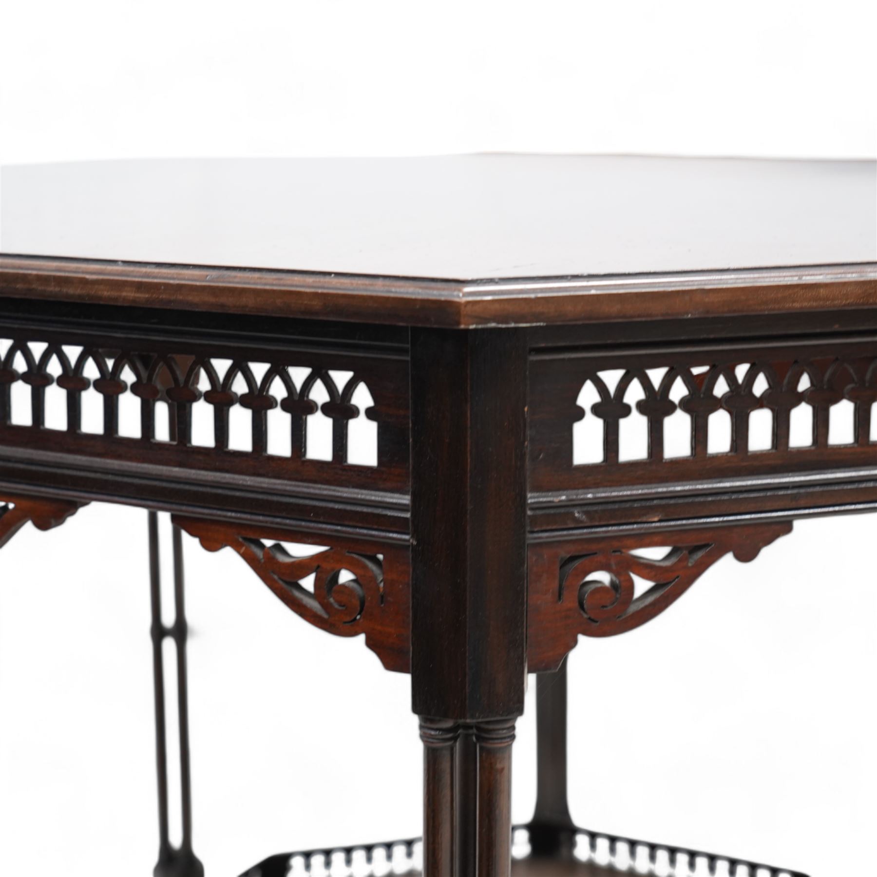 Late 19th to early 20th century mahogany octagonal centre table, moulded top over pierced arcade frieze rails and fretwork brackets, on eight cluster column supports terminating to turned feet, united by under tier with raised gallery 