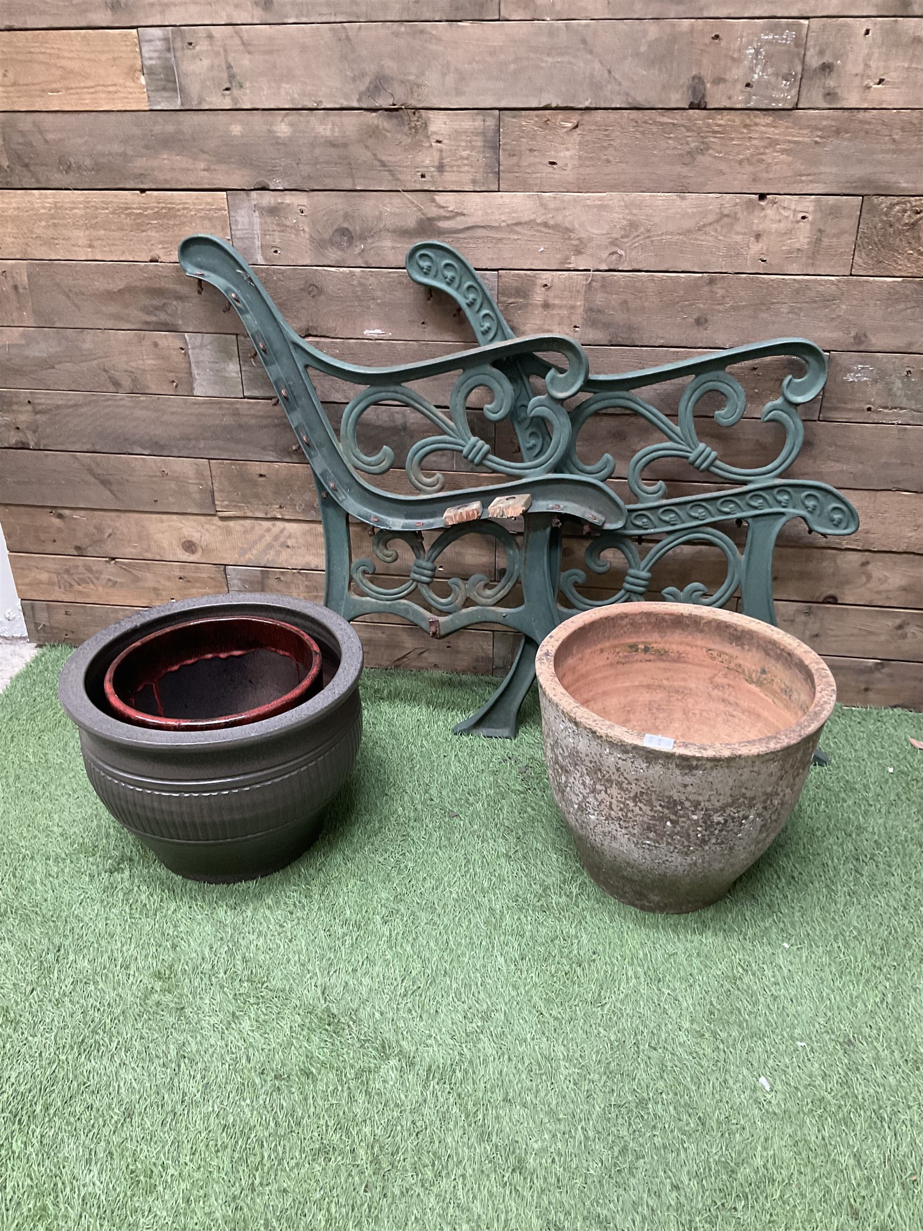 Cast stone garden fruit centrepiece on square base, pair of cast iron bench ends, and three planters - THIS LOT IS TO BE COLLECTED BY APPOINTMENT FROM DUGGLEBY STORAGE, GREAT HILL, EASTFIELD, SCARBOROUGH, YO11 3TX