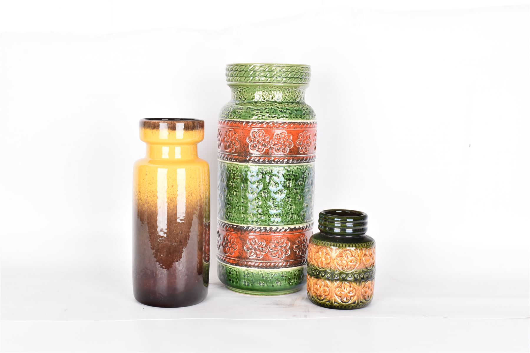 Three West German vases, to include orange and green example with floral decoration and a similar smaller example, tallest H40cm