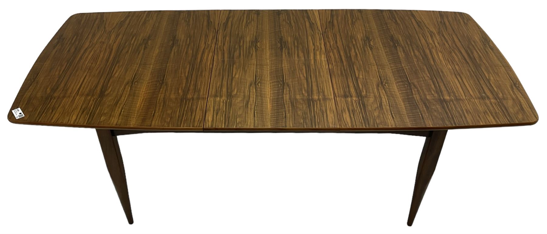 Mid-20th century figured walnut extending dining table, pull-out action with fold-out leaf, on tapering supports 