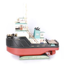 Modern model of American Coastal and River Tugboat 'Maya', in red, black and light blue finish, upon a green stand inscribed with name, H53cm, W52cm 