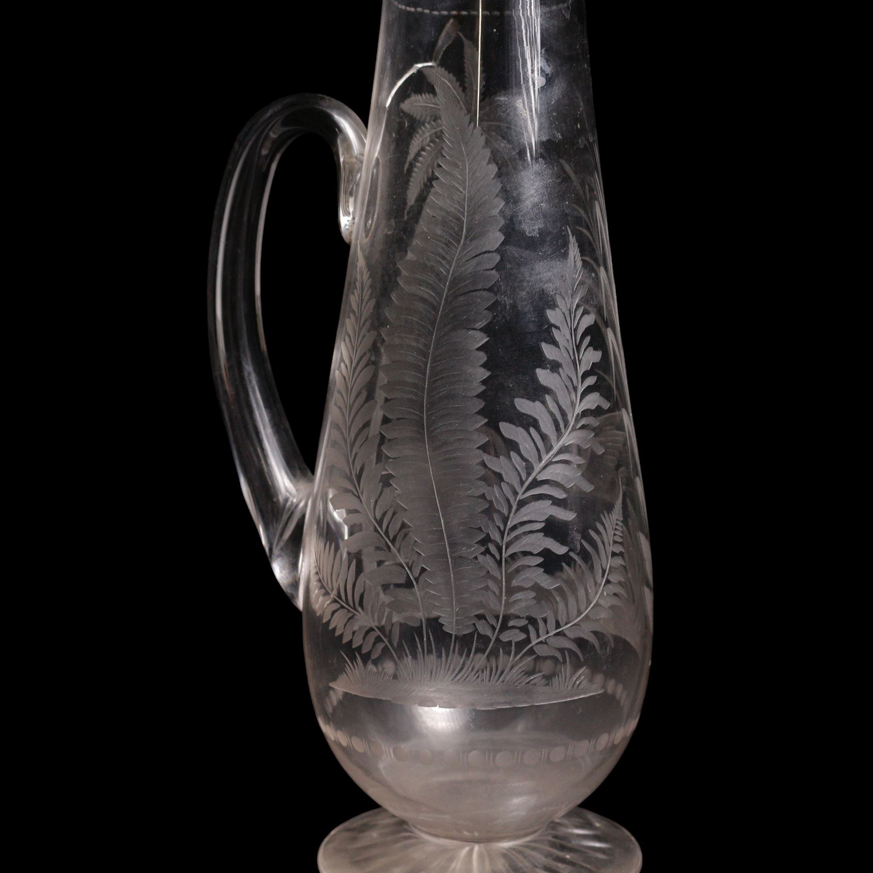 19th/ early 20th century crystal water jug, probably Stourbridge, of baluster form engraved with two Swans on a lake, amongst ferns, reeds and a palm tree, on circular pedestal star engraved foot, H28cm, heavy cut glass jar and cover on pedestal foot, together with a Lalique Samoa frosted glass scent bottle, signed Lalique, France, and labelled 11312 H8cm (3)