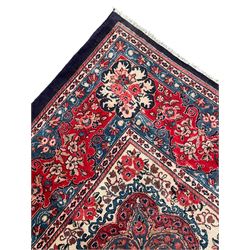 Persian Mahal indigo ground carpet, floral medallion on a field of swirling leafy branches and flower heads, shaped ivory field band decorated with flower head bouquets and trailing branches, the border decorated with floral motifs, within guard stripes