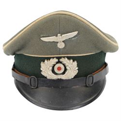 WWII German, Third Reich army NCO visor cap, green doeskin wool with a forest green centreband and cream piping, featuring a silver alloy army eagle and a silvered wreath