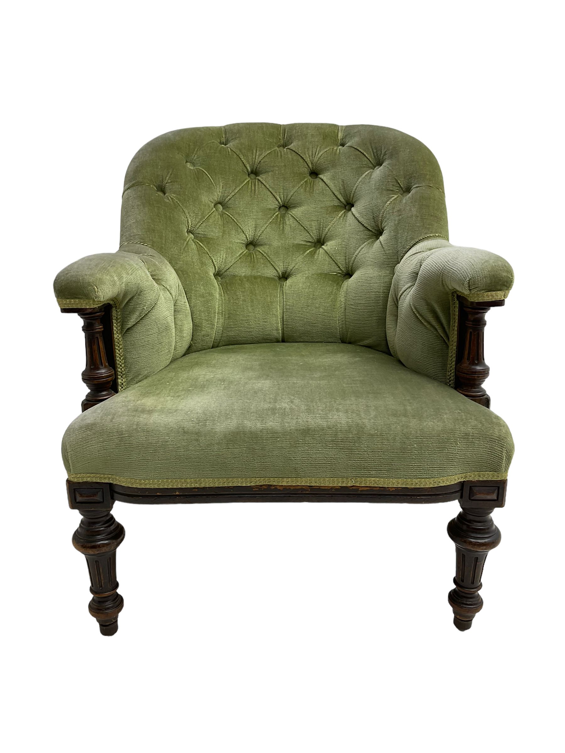 Victorian mahogany framed armchair, upholstered in buttoned sage green fabric with sprung seat, raised on turned and fluted front supports with matching arm terminal column supports