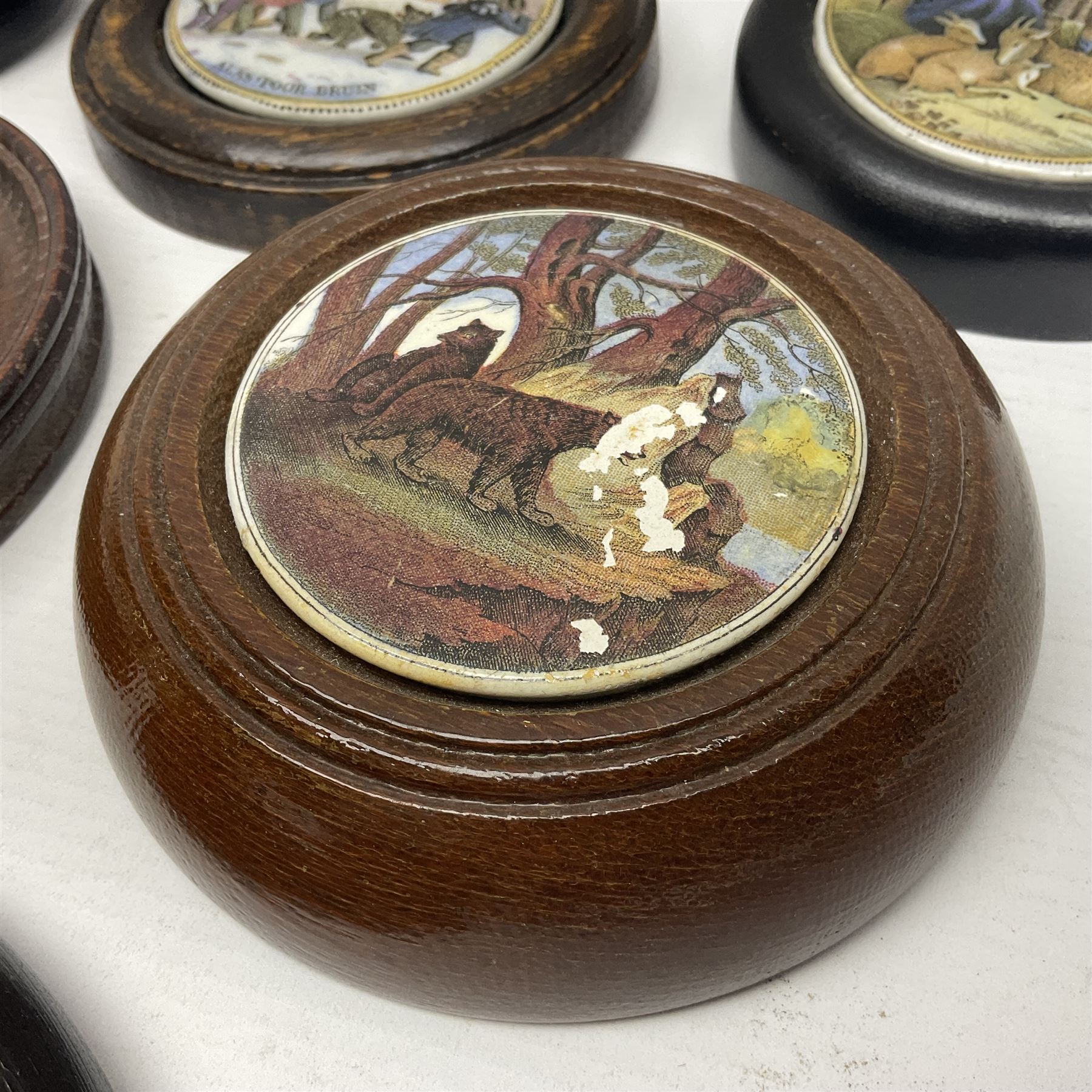 Six framed Prattware pot lids comprising 'Bear, Cock & Lion', 'Bear on Rock', 'Alas! Poor Bruin', ' Lady, Boy and Goats', 'The Shrimpers' and one other, largest D15.5cm (6)