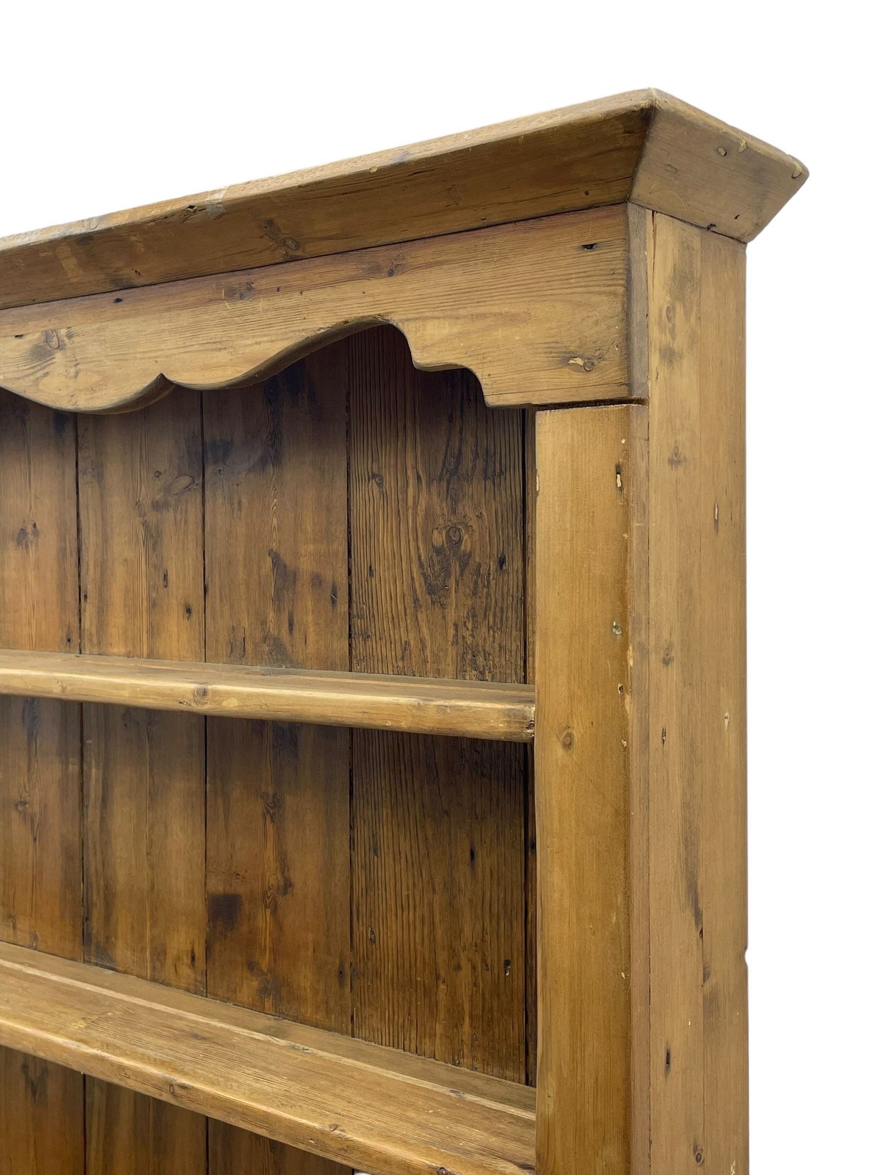 Waxed pine 'chicken coop' or 'hutch' dresser, projecting cornice over shaped frieze and three tier plate rack, the stepped waterfall lower section fitted with two slatted chicken coops, on sledge feet 