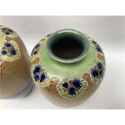 Pair of Royal Doulton Lambeth stoneware baluster vases, decorated in light relief with foliage, impressed mark beneath, H23cm