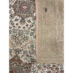 Large Persian design carpet, overall floral design, the field decorated with large rosette motifs surrounded by trailing foliate motifs, the border decorated with trailing branch and stylised plant motifs