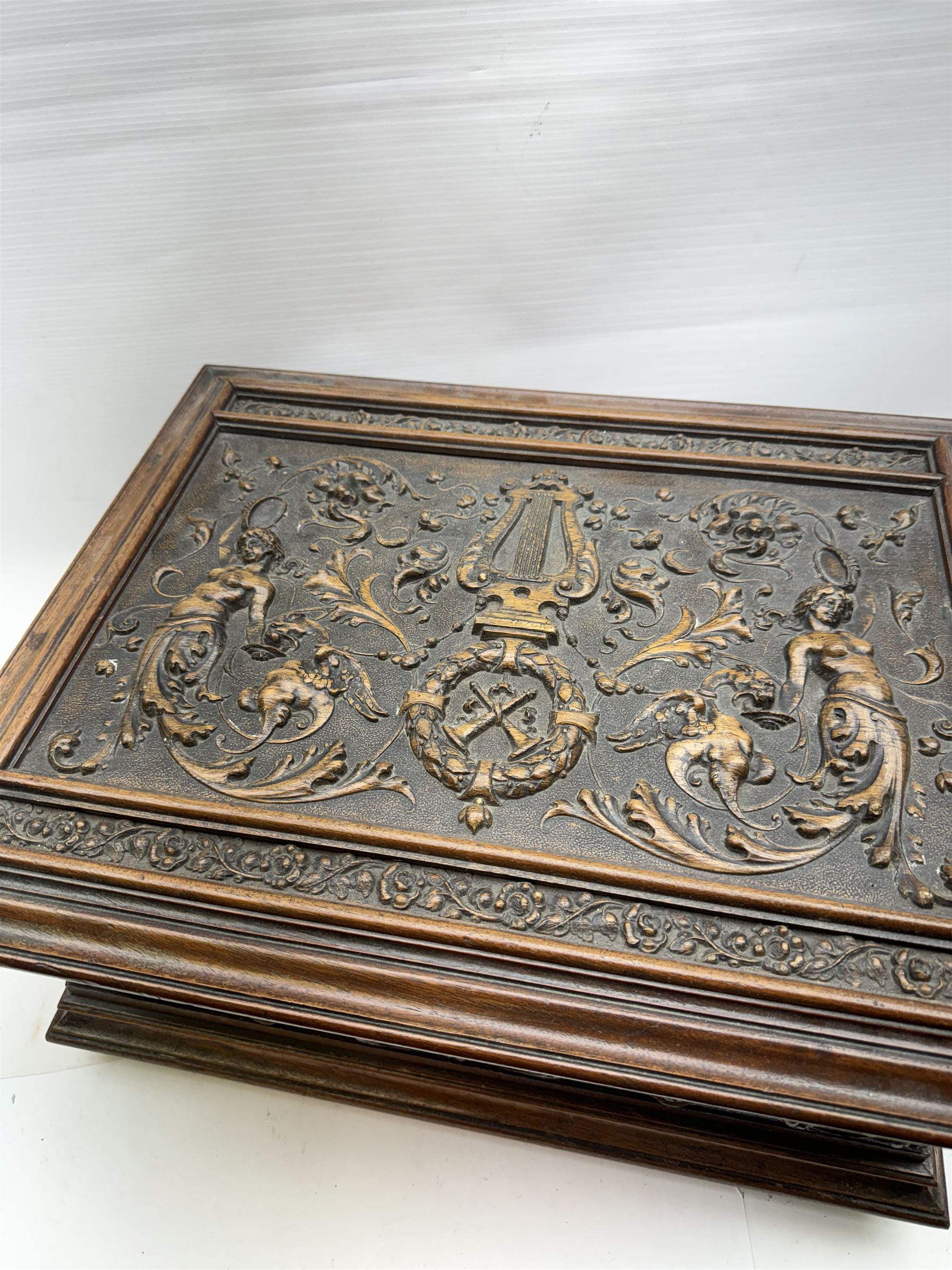 19th century Continental mahogany and oak box, carved in high relief with classical figures, harp, musical trophies, anthemion and foliate motifs, H22.5cm L48cm D38.5cm