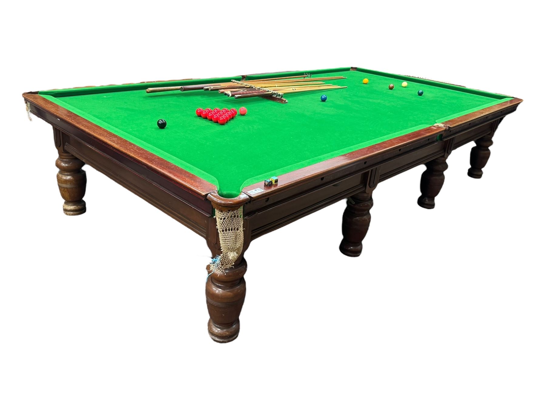 Riley - early 20th century full-sized mahogany billiards or snooker table, on eight turned baluster supports, with cue rack, scoreboard, balls and various cues 