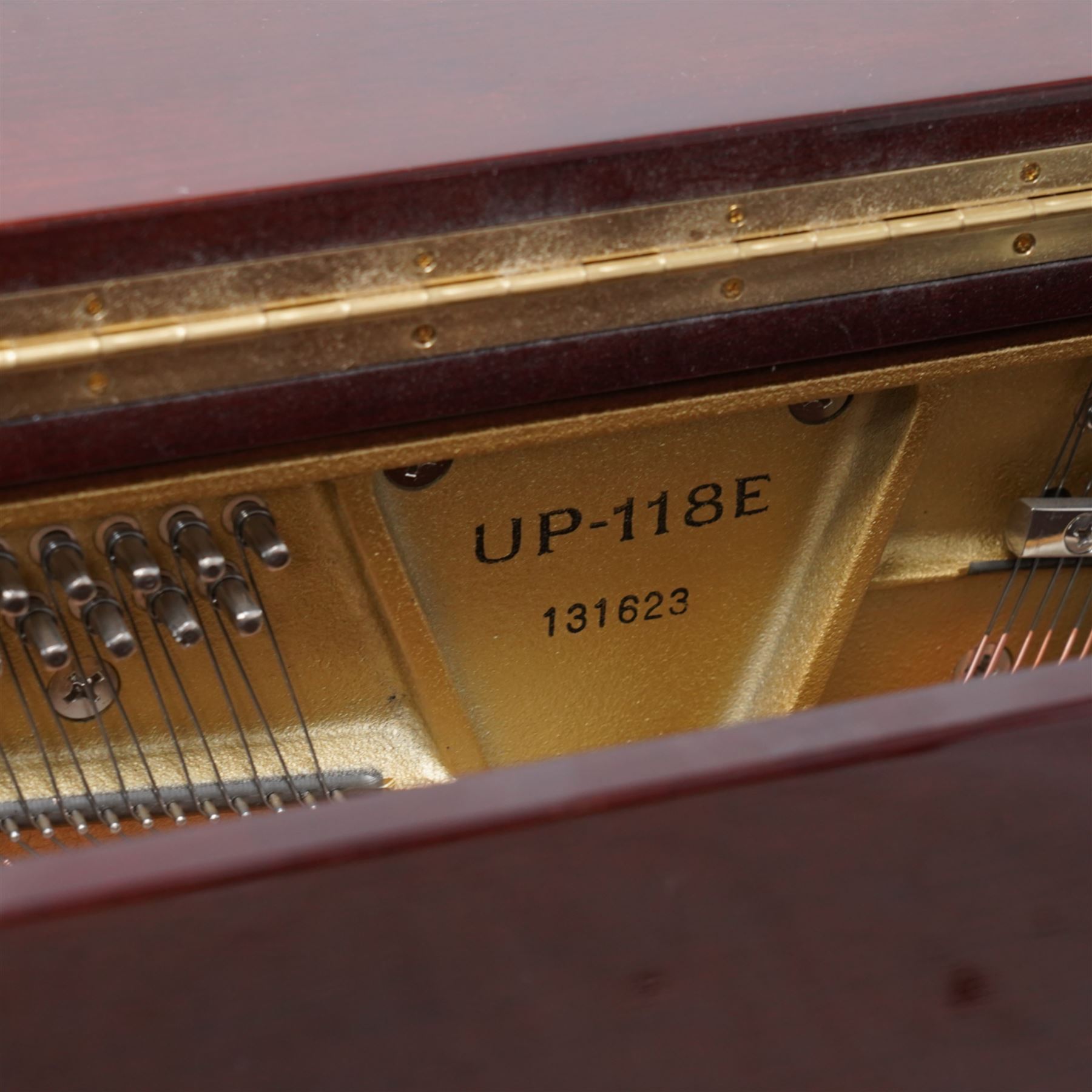 Boston - Upright overstrung piano in a lacquered mahogany case, designed by Steinway and manufactured by Kawai in Japan, Model 118E, serial No 131623 (1999), with 88 synthetic ivory/ ebony keys (seven octaves) with mute, una-corda and sustain pedals, original nickel plated tuning pins, hammers, strings and damper felts. With matching duet stool.